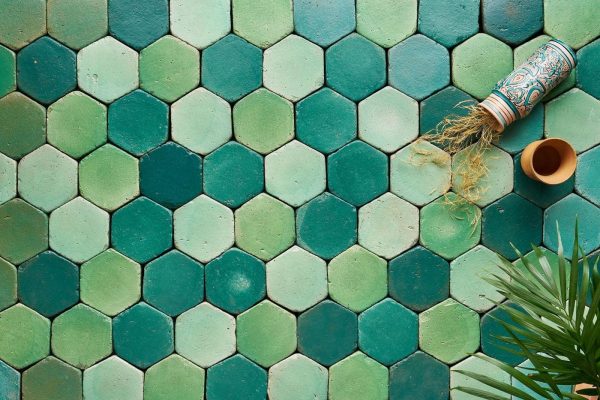 Composition of green glazed terracotta tiles in different shades and hues